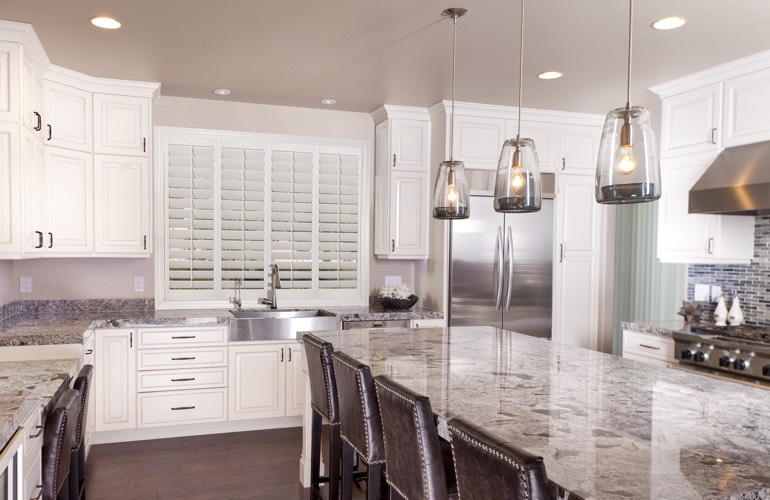 A modern kitchen with plantation shutters